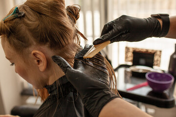 .Close-up of female hands holding the hair rows in professional hairstyles salon. The hairdresser...