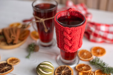 Mulled hot wine with spices with dry fruits in cups on wooden table