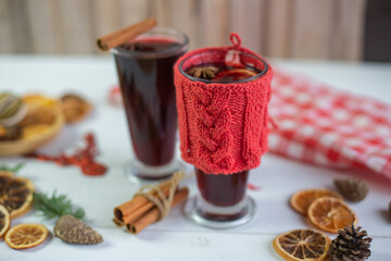 Mulled hot wine with spices with dry fruits in cups on wooden table