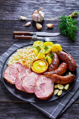 bratwurst, pork, potatoes, sauerkraut on a plate