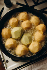 peeled apples are caramelized in a fry pan with butter. caramelizing apples for making tart tatin.