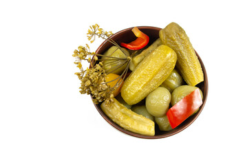 Close-up of pickled vegetables in a ceramic cup on a white background. Top view.