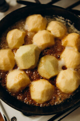 peeled apples are caramelized in a fry pan with butter. caramelizing apples for making tart tatin.