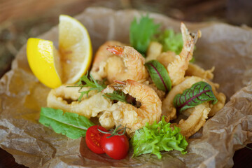 Shrimp, squid rings and other seafood deep-fried in batter.