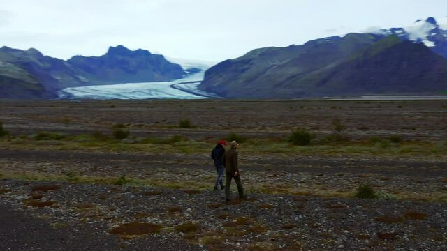 Two Men Walking And Exploring At Skeidararsandur Plain Near Famous Svinafellsjokull And Skaftafell Glaciers In Iceland. - aerial
