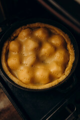 cooking tarte tatin top view. ready apple pie before baking in the oven. the dough covered the apples underneath.