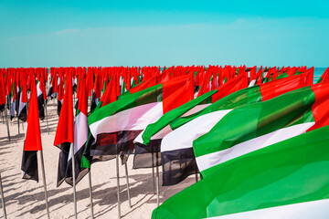 Flags of the United Arab Emirates waving in the wind on a kite beach in Dubai