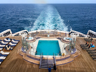 Passengers enjoying open outdoor promenade sun decks of legendary ocean cruiseship cruise ship...