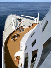 Passengers enjoying open outdoor promenade sun decks of legendary ocean cruiseship cruise ship...