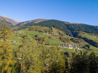 Obraz premium view of green mountains and meadows, and the village