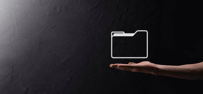 Businessman hold folder icon.Document Management System or DMS setup by IT consultant with modern computer are searching managing information and corporate files.Business processing,