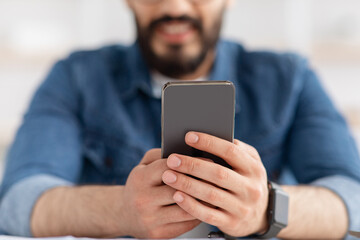 Gadgets, mobile applications concept. Closeup of modern smartphone in male hands, man surfing internet online