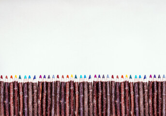 Wooden pencils isolated on white background. Handmade colored crayon pencils. Arts and crafts poster design 