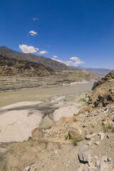 Fototapeta na wymiar Nice View to the Dirty Water of Mountain River in Gilgit Baltistan Region, Pakistan