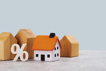 mortgage calculator or real estate business concept. Office desk with a white and wooden houses....
