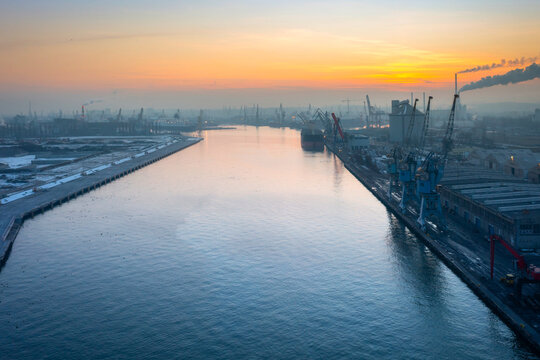 Scenery of port cranes by the Martwa Wisla river at sunset, Gdansk. Poland.