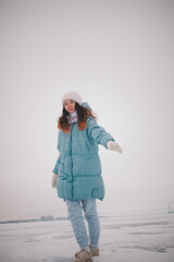 a beautiful girl walks on a frozen lake