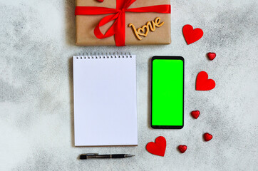 valentines day greeting card, festive gift box with red ribbon and wooden decorations shape heart, eco friendly craft package and zero waste holiday, green screen cell phone chroma key