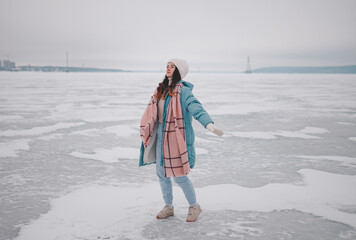 a beautiful girl walks on a frozen lake