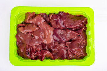 Healthy offal. Raw chicken liver on white. Studio Photo