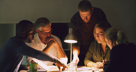 Their deadline is coming up. Cropped shot of a group of businesspeople working together around a table in their office.