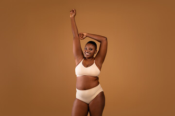 Portrait of beautiful plus size African american woman showing armpits - obrazy, fototapety, plakaty