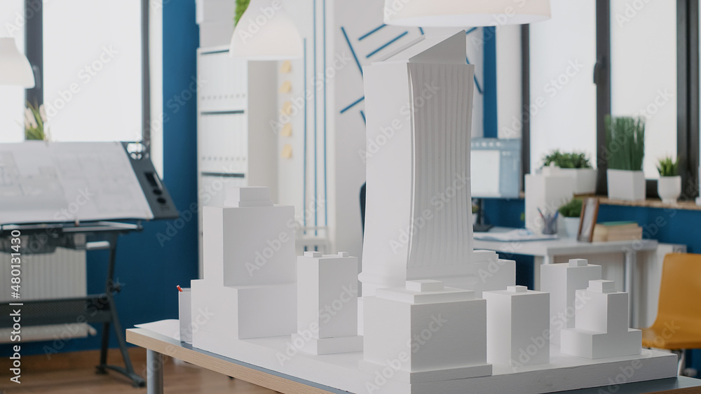 Poster empty architectural office with building model and maquette on table. nobody in space with blueprint