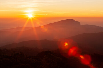 The sun rising over mountains on a winter day. - 480131692