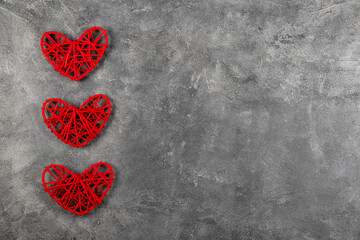 Valentines day background with red hearts on a gray background, greeting card with free space for text