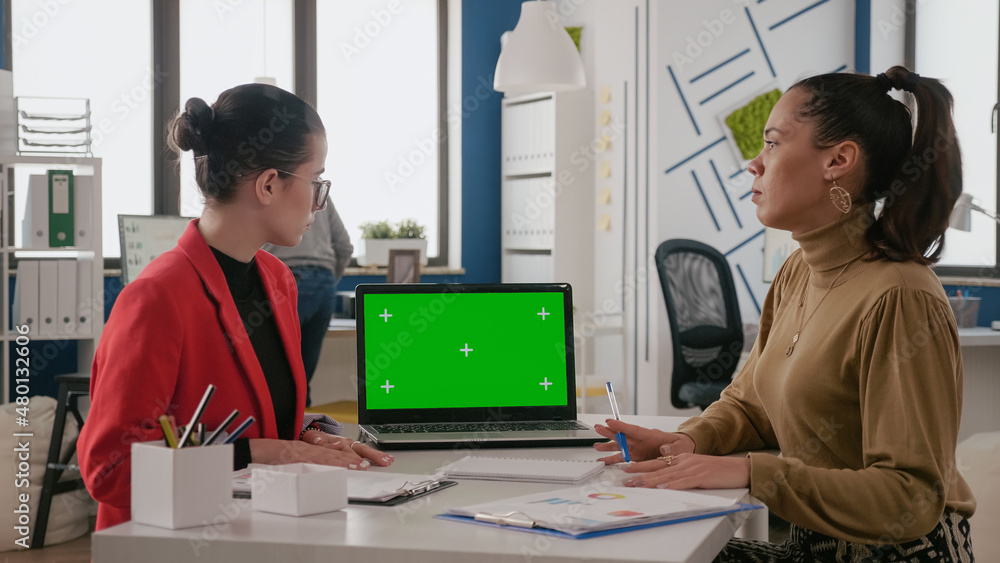 Poster team of women working with green screen on laptop in business office. coworkers using mock up templa