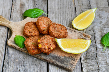 Home made  oven baked  mini meatballs  from  chicken and vegetable on  wooden background