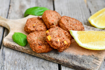 Home made  oven baked  mini meatballs  from  chicken and vegetable on  wooden background