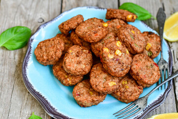 Home made  oven baked  mini meatballs  from  chicken and vegetable on  wooden background