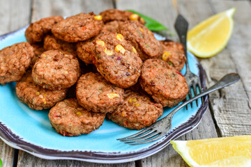 Home made  oven baked  mini meatballs  from  chicken and vegetable on  wooden background