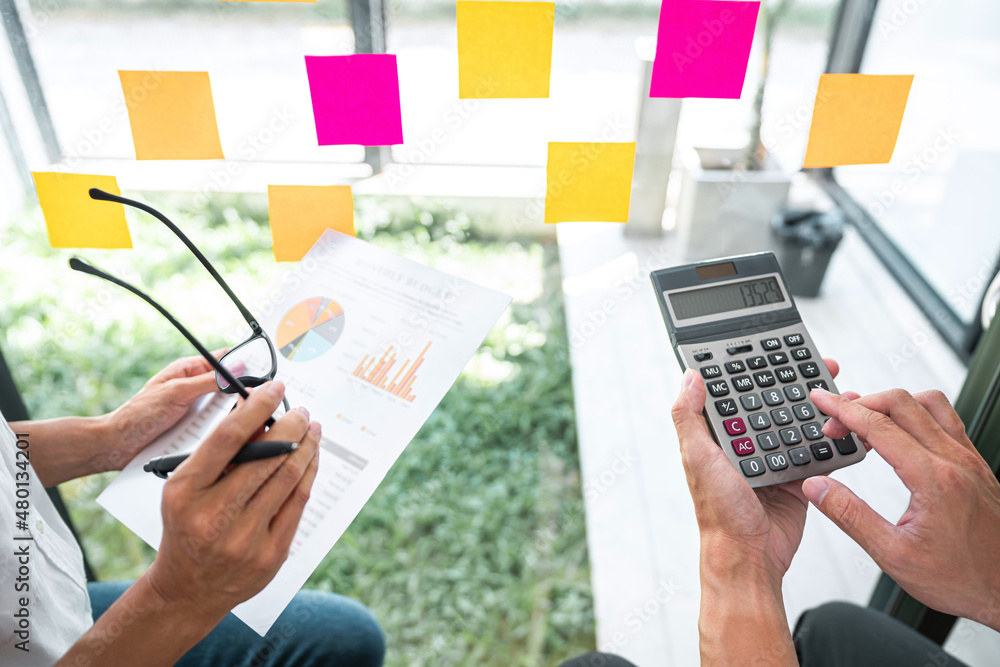 Poster business team working marketing growth on financial document graph report statistics, using post it 