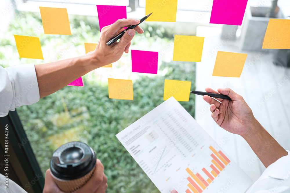 Poster business team working marketing growth on financial document graph report statistics, using post it 