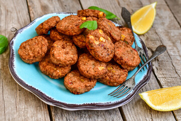 Home made  oven baked  mini meatballs  from  chicken and vegetable on  wooden background