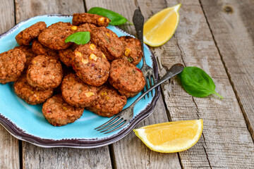 Home made  oven baked  mini meatballs  from  chicken and vegetable on  wooden background