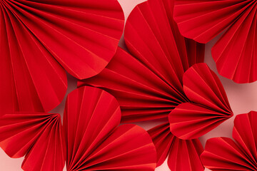Elegant luxury Valentine day background with bright passion red paper origami hearts as pattern, texture, closeup, top view.
