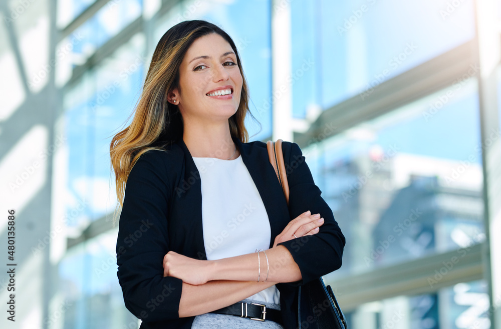 Canvas Prints Hard work first then happiness will follow. Cropped portrait of an attractive young businesswoman smiling while standing with her arms crossed in a modern office.