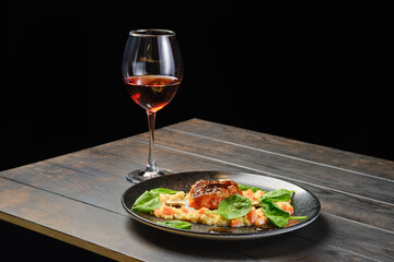 Roasted salmon fillet with bulgur with glass of rose wine