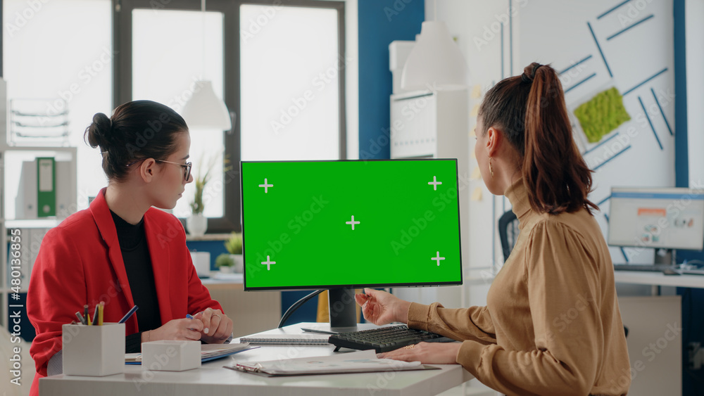 Poster people doing teamwork with green screen on monitor. women coworkers using computer display with isol