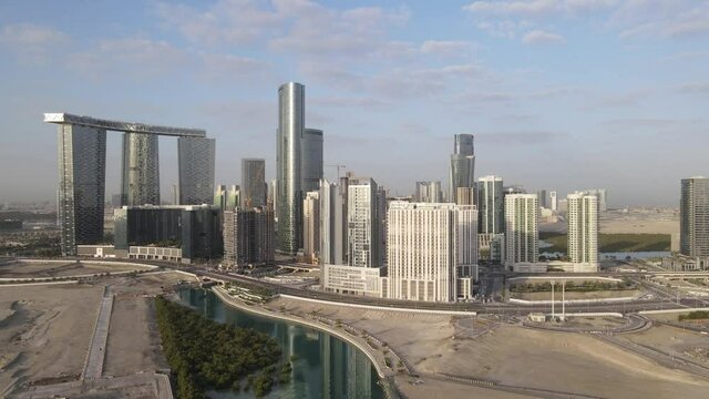 Aerial view on developing part of Al Reem island in Abu Dhabi on a cloudy morning. Drone footage.