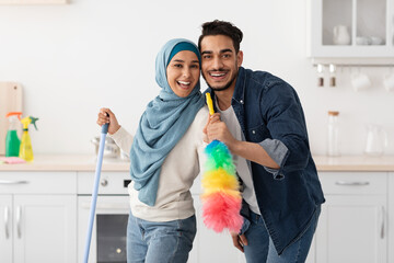 Happy arab lovers enjoying house-keeping at home