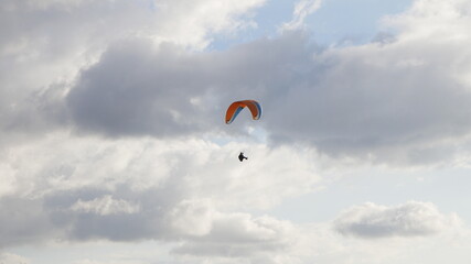Paragliders flying in a dramatic sky of storm clouds over Cenes de la Vega, Granada, Spain