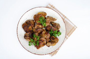 Cooked chicken liver on plate. Liver dishes. Studio Photo