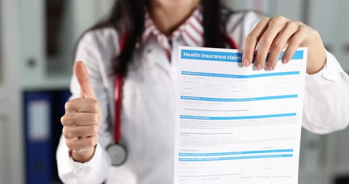 Doctor is holding health insurance blank and thumbs up gesture