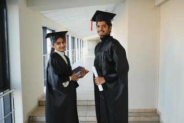 education, graduation and people concept - group of happy indian students