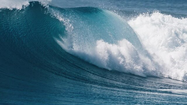 Powerful ocean wave breaks at the Sultans surf spot in Maldives
