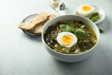 Traditional homemade green soup with hard boiled eggs